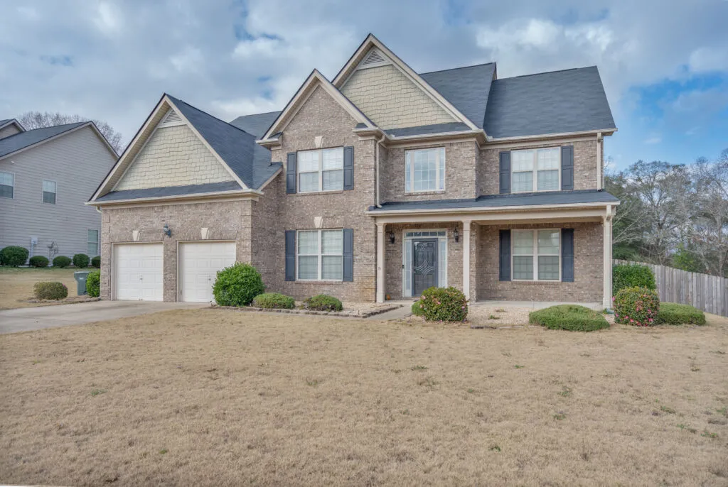 Two-story brick home with a manicured lawn in metro Atlanta