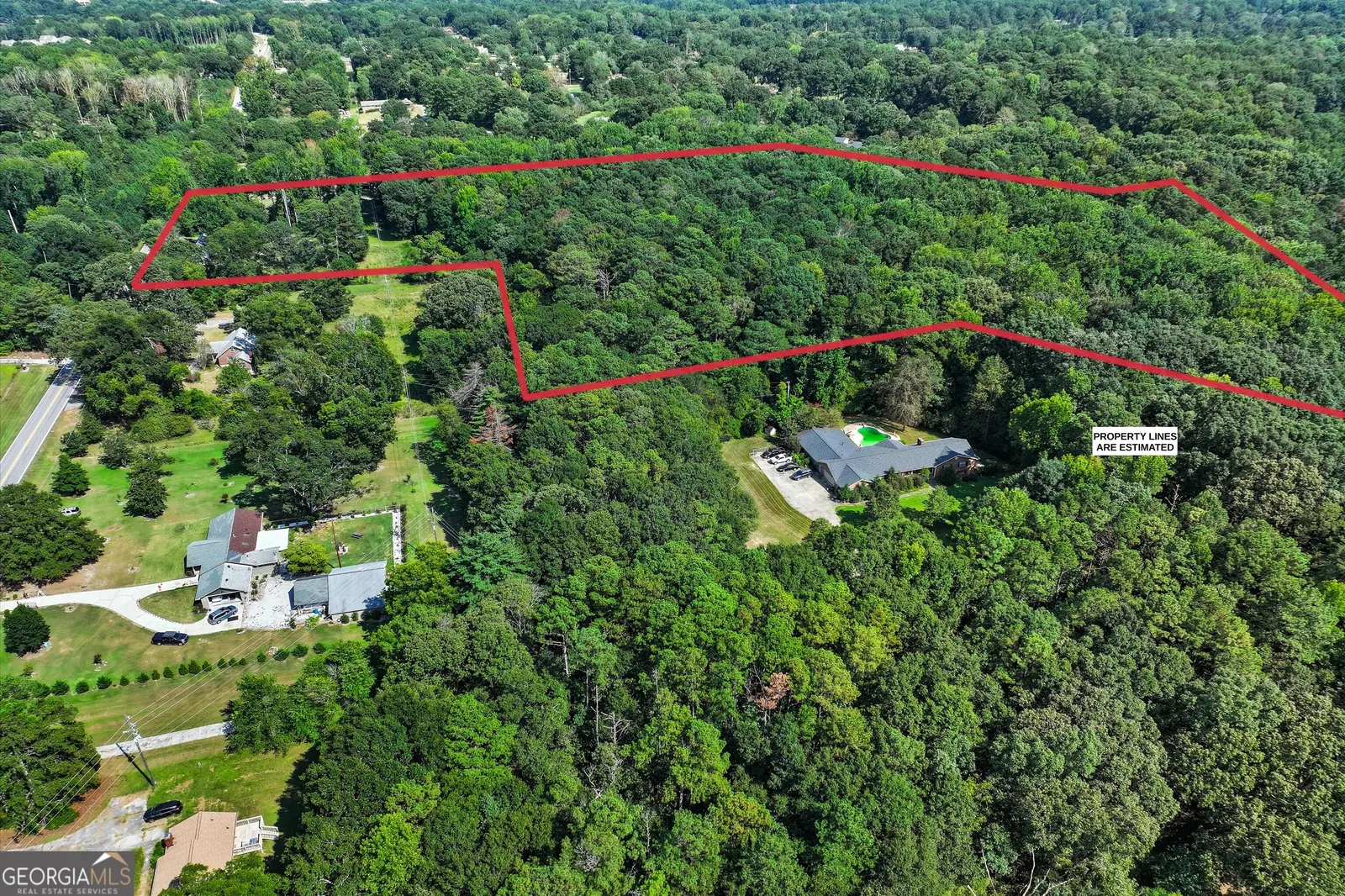 Aerial view of the parcel boundary with the house and driveway visible at the lower left