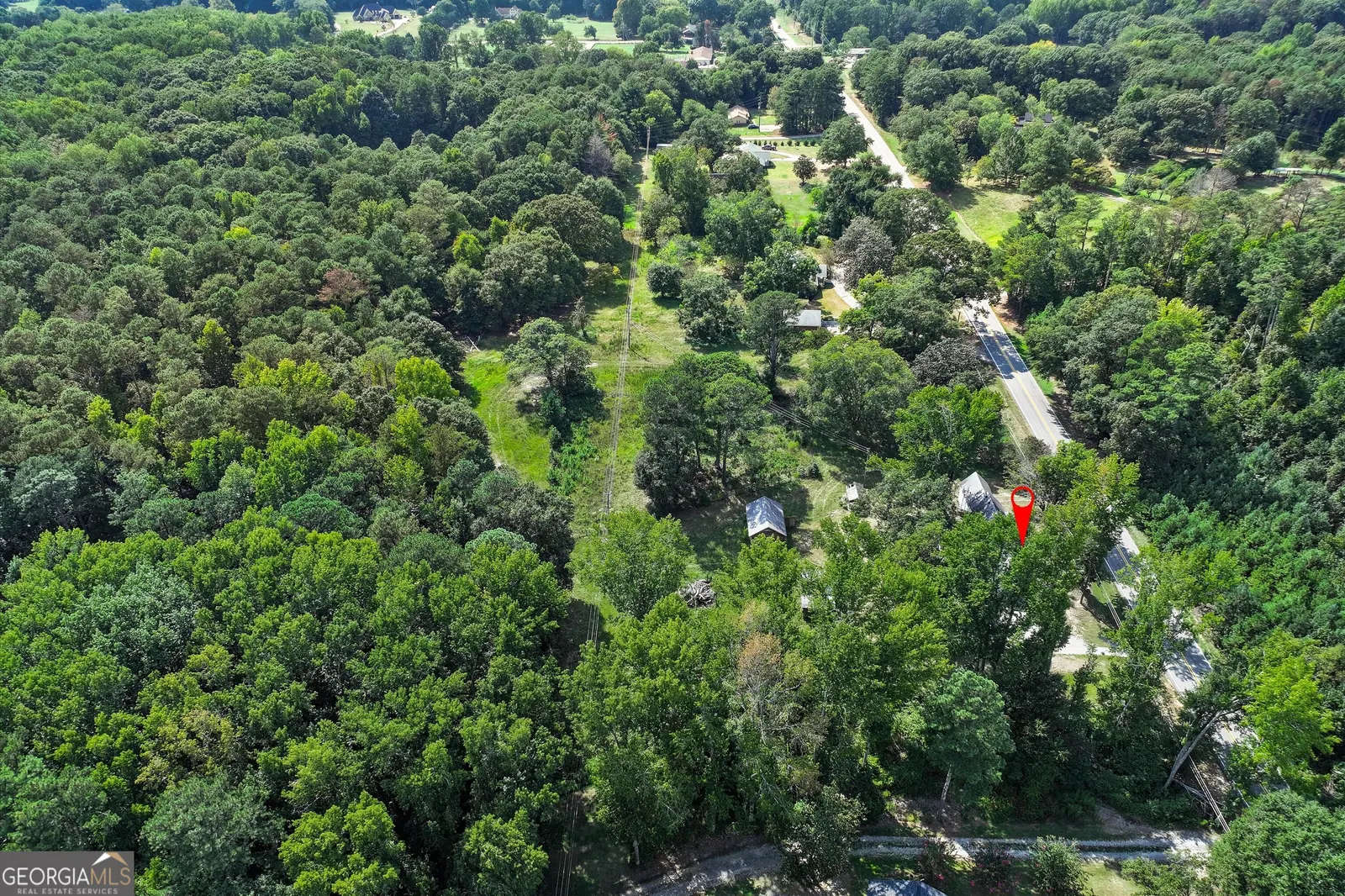 Aerial looking across the wooded neighbourhood, with Klondike Road running through it