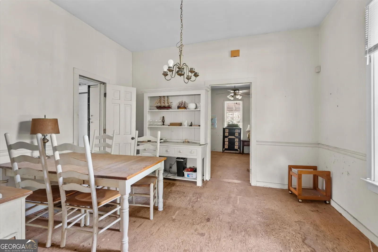 Dining room from the other side, showing built-in shelving and the hallway beyond