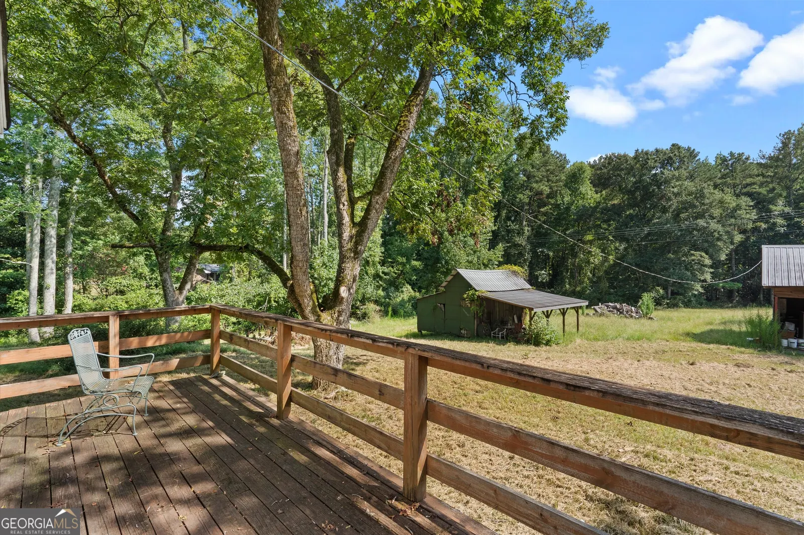 The view from the deck across the lawn toward the outbuildings