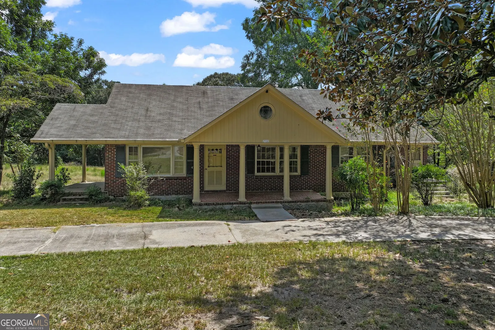 Front of the brick ranch at 2130 Klondike Rd SW, with a covered carport and a concrete drive