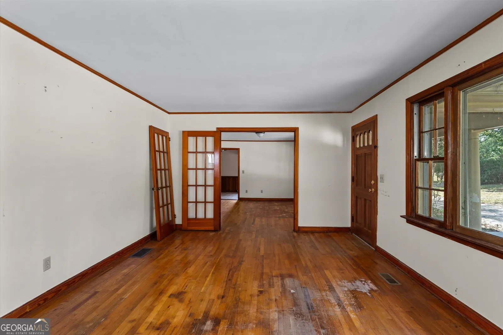 Living room with hardwood floors, french doors and a large picture window