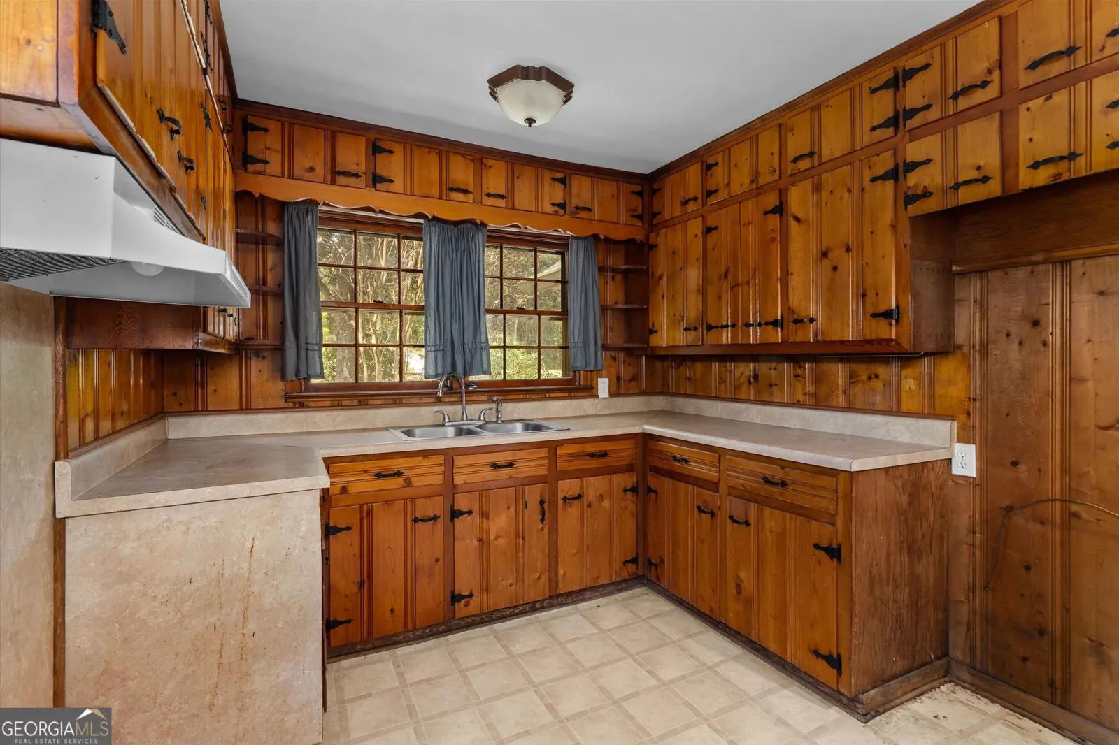 Kitchen from the other side, showing the U-shaped counters and range hood
