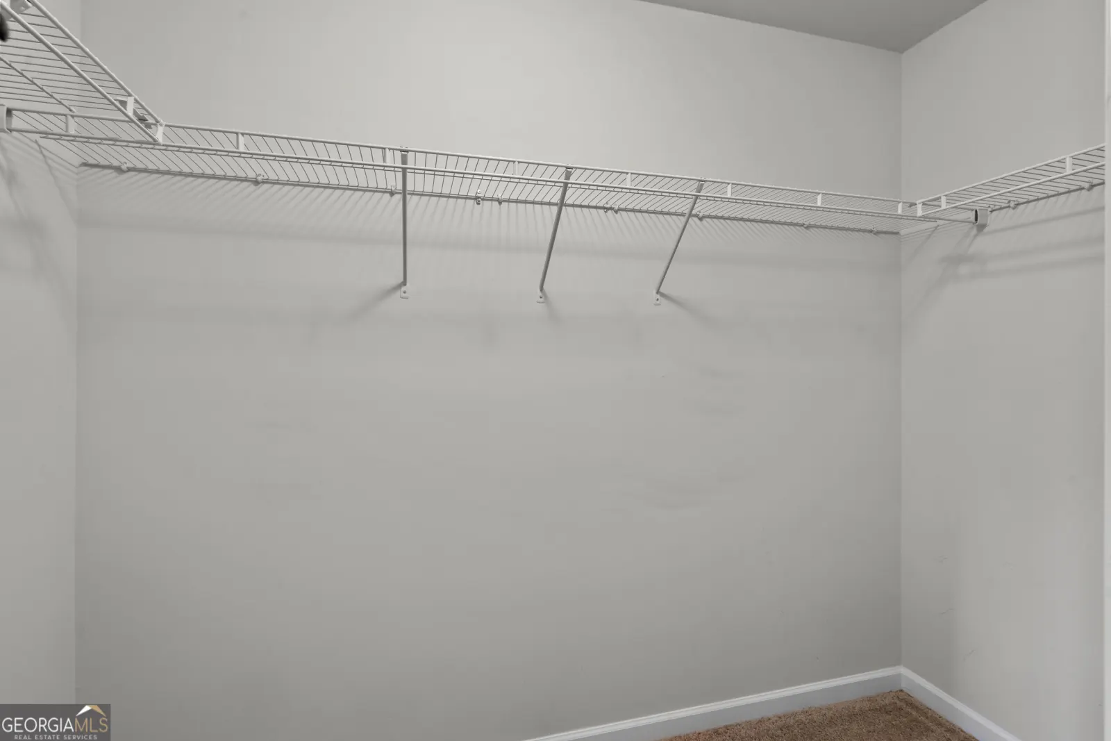 Primary walk-in closet with wire shelving