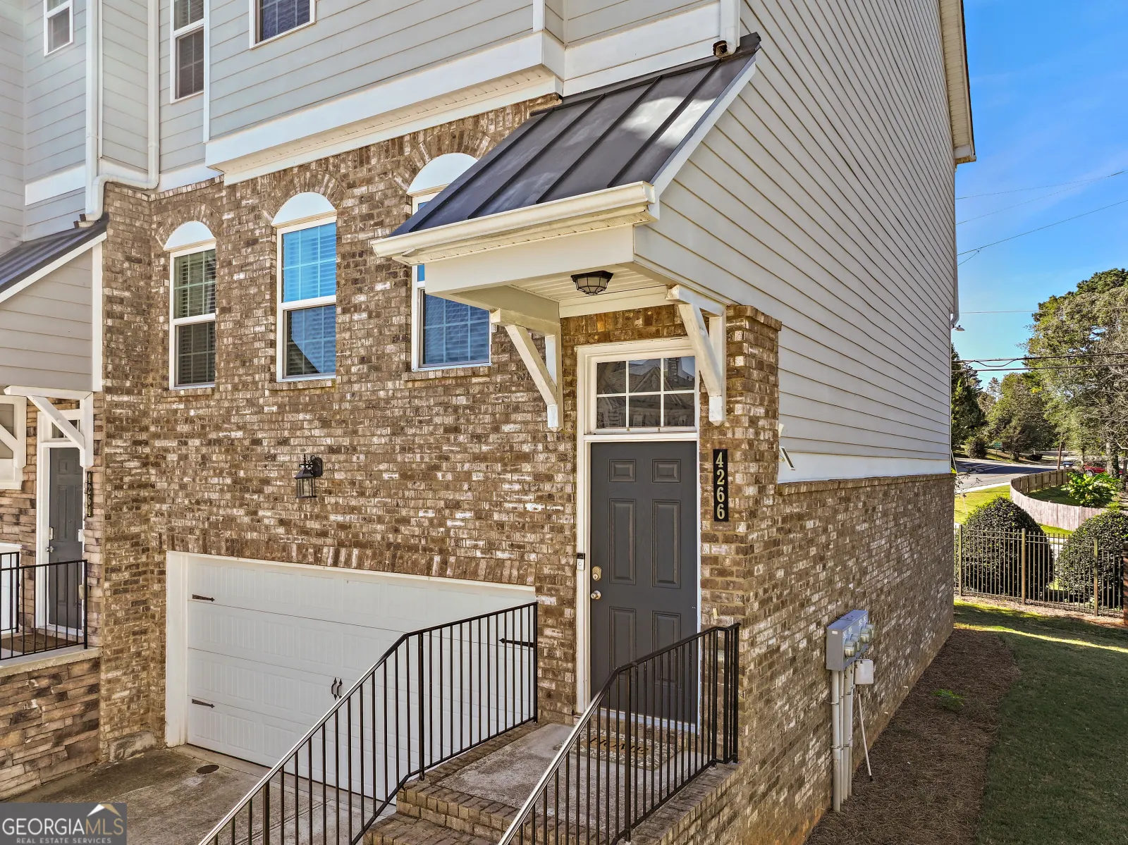 Brick front and covered entry of the end unit